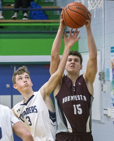 Adam Monteith of Stratford Northwestern Secondary School wins the battle for a rebound against Brandon Feagan of Catholic Central High School during their WOSSAA "AAA" match at Sir Wilfrid Laurier Secondary School  in London, Ont. on Wednesday February 26, 2020. CCH won the game , 53-39. Derek Ruttan/The London Free Press/Postmedia Network