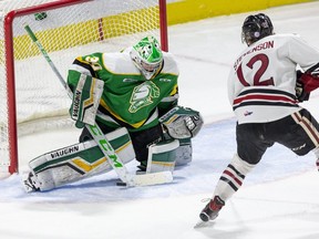 Keegan Stevenson of the Guelph Storm tucks the puck under the pad of London Knights goalie Brett Brochu to give the storm a 2-0 lead in the first period of their game at Budweiser Gardens in London, Ont., Wednesday Feb. 26, 2020.  Derek Ruttan/The London Free Press