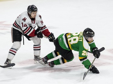 London Knight Ryan Merkley trips in front of the Guelph Storm's Cedric Ralph during the first period of their game in London, Ont. Derek Ruttan/The London Free Press/Postmedia Network
