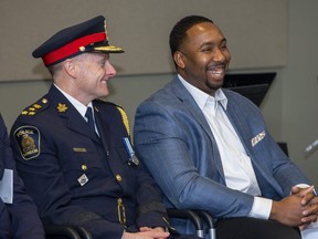 Police chief Stephen Williams laughs with Cleveland Brownlee prior to the London Majors star's keynote speech at the Lewis Coray Trailblazer Awards Evening of Inspiration at police headquarters in London, Ont. The Trailblazer Awards were created nine years ago in honour of Sergeant (Ret.) Lewis 'Bud' Coray, London's first black police officer. (Derek Ruttan/The London Free Press)