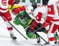 Jonathan Gruden of the London Knights gets mugged by Robert Calisti of the Soo Greyhounds during the first period of their game on Feb. 28, 2020 in London. (Derek Ruttan/The London Free Press)