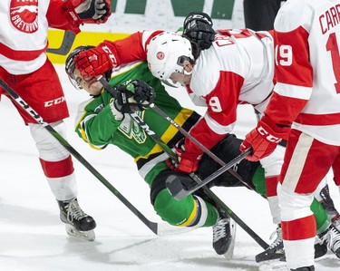 Jonathan Gruden of the London Knights gets mugged by Robert Calisti of the Soo Greyhounds during the first period of their game in London. (Derek Ruttan/The London Free Press)