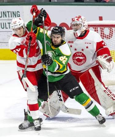 Jason Willms of the London Knights duels with Jaromir Pytlik of the Soo Greyhounds Nick Malik during the first period of their game in London. (Derek Ruttan/The London Free Press)