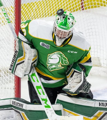 A shot caroms off the helmet of London Knights goalie Brett Brochu during the first period of their game against the Soo Greyhounds in London, Ont. (Derek Ruttan/The London Free Press)