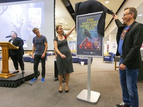 London councillors Elizabeth Peloza and Shawn Lewis unveil The Saturday Night Ghost Club as the One Book One London selection with Sarah Andrews the co-chair and author Craig Davidson in the Central Library.  (Mike Hensen/The London Free Press)
