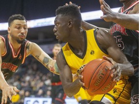 Otas Iyekekpolor of the London Lightning gets double teamed by Ryan Anderson and Kemy Osse of the Windsor Express during the first half of their NBL of Canada game on Thursday, Janarya 2, 2020 at Budweiser Gardens in London, Ont. (Mike Hensen/The London Free Press)