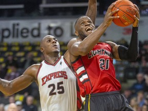 Abednego Lufile of the Lightning drives in around Derrick Nix of the Windsor Express in a recent game.  (Mike Hensen/The London Free Press file photo)