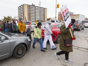 Teachers from Saunders Secondary, Westminster SS, Jean Vanier Catholic Elementary and Westmount Public School cross a gridlocked Wonderland Road as they picket in London, Ont.. Photograph taken on Tuesday February 4, 2020.  Mike Hensen/The London Free Press/Postmedia Network