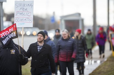 Jeremy Lenk, who teaches music, geography and special education at Saunders walks with other teachers from Westminster SS, Jean Vanier Catholic Elementary and Westmount Public School who were picketing on Wonderland Road in London, Ont.. Photograph taken on Tuesday February 4, 2020.  Mike Hensen/The London Free Press/Postmedia Network