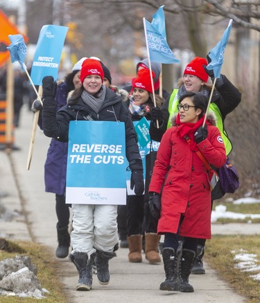 Teachers Jean Vanier Catholic Elementary picket as members of the Ontario English Catholic Teachers Association wave flags and wear their signs as they picket on Wonderland Road as they picket in London, Ont.. Photograph taken on Tuesday February 4, 2020.  Mike Hensen/The London Free Press/Postmedia Network