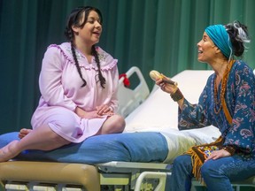 Andrea Menard, as Anna-Rae, sings with her mom, played by Tai Grauman, in the Grand Theatre's production of Honour Beat, in which two estranged daughters come together at their dying mom's bed. (Mike Hensen/The London Free Press)