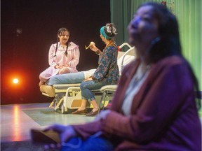 Tai Grauman as mom (left) sings with her daughter Anna-Rae (centre, played by Andrea Menard) while her other daughter Rae-Anna (played by Tracey Nepinak, right) sits outside the hospital during the Grand Theatre's media call for Honour Beat in London, Ont.  Honour Beat deals with the dynamics of two estranged daughters coming together at their dying mom's bed. Photograph taken on Tuesday February 4, 2020.  (Mike Hensen/The London Free Press)