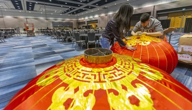 Co-chairs Vivian Iron and Alan Chan, of the Chinese Canadian National Council's London Chapter Dragon Festival assemble huge Chinese lanterns before they are lifted to the ceiling at the RBC Place London.  570 guests are expected Saturday night for the celebration of the Chinese New Year, with a charity component going towards El Sistema Aeolian. (Mike Hensen/The London Free Press)