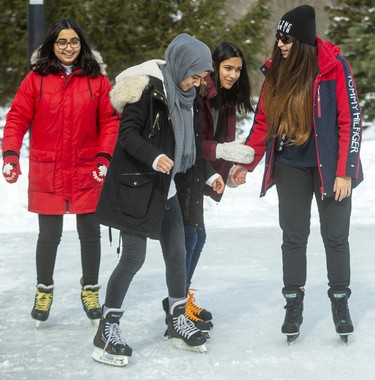Ayshah Chaudhari, left, and her sister Annie Chaudhari, right, from Windsor were in London to visit Mirha Raza (second from left) and Eshal Raza. For Mirha this wasn't her first time on skates, but she hadn't been on ice for several years, and so was taking it pretty easy at first. Photograph taken on Sunday February 9, 2020.  Mike Hensen/The London Free Press/Postmedia Network