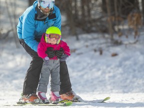 Mika Kueneman, 2, of London, gets a faster ride down the slopes with her dad Matt holding her upright at Boler Mountain on Sunday. Mike Hensen/The London Free Press/Postmedia Network