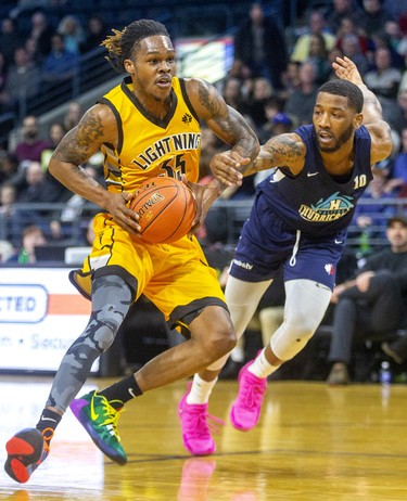 AJ Gaines of the London Lightning drives and is fouled by Tyler Scott of the Halifax Hurricanes during their Sunday afternoon game at Budweiser Gardens in London. Photograph taken on Sunday February 9, 2020. Mike Hensen/The London Free Press/Postmedia Network