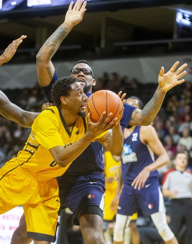 Marcus Capers of the London Lightning tries for a shot as he's knocked to the court by Halifax's Carl Hal during their Sunday afternoon game at Budweiser Gardens in London. Photograph taken on Sunday February 9, 2020. 
Mike Hensen/The London Free Press/Postmedia Network