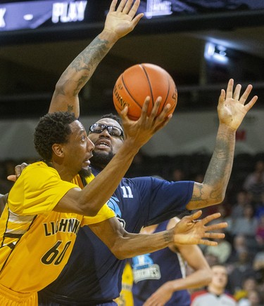 Marcus Capers of the London Lightning tries for a shot as he's knocked to the court by Halifax's Carl Hal during their Sunday afternoon game at Budweiser Gardens in London. Photograph taken on Sunday February 9, 2020. 
Mike Hensen/The London Free Press/Postmedia Network