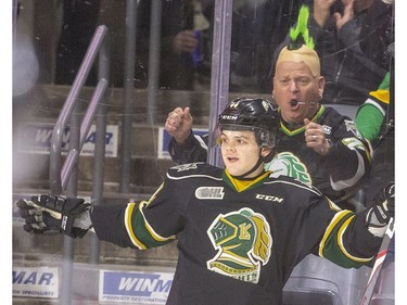 Jonathan Gruden of the London Knights celebrates his first-minute goal against the Guelph Storm with Knights fan Jim Stevens, wearing a fake mohawk, cheering him on at Budweiser Gardens in London, Ont.  Tuesday Feb. 11, 2020.  Mike Hensen/The London Free Press