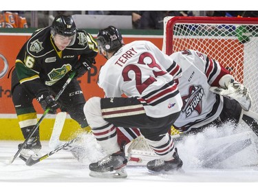 Sean McGurn of the London Knights has a chance from the side of the Guelph Storm net against Nico Daws in net and Zack Terry coming back on defence during their game at Budweiser Gardens in London, Ont., Tuesday Feb. 11, 2020.  Mike Hensen/The London Free Press