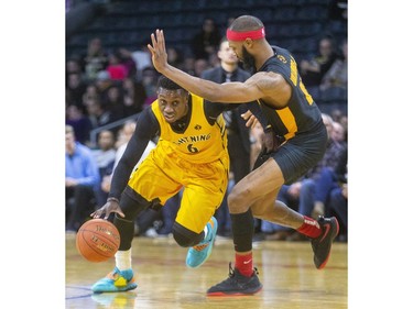 Marvin Binney of the Lightning drives under the arm of Sudbury's Dexter Williams during their NBL game at Budweiser Gardens in London, on Thursday February 13, 2020.  Mike Hensen/The London Free Press/Postmedia Network