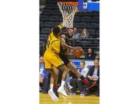 Marcus Capers of the Lightning tries for another stuff as he stops Sudbury's Dexter Williams baseline during their NBL game at Budweiser Gardens in London, on Thursday Feb. 13, 2020.  Mike Hensen/The London Free Press