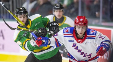 Knights forward Luke Evangelista and Kitchener's Mike Petizian fight for position near the boards in the Knights end during the first period of their Friday night game at Budweiser Gardens in London. Photograph taken on Friday February 14, 2020. 
Mike Hensen/The London Free Press/Postmedia Network