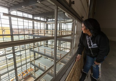 Martha Leach looks out of the atrium being constructed on the northwest side of the building at 100 Kellogg Lane. Photograph taken on Tuesday February 18, 2020.  Mike Hensen/The London Free Press/Postmedia Network