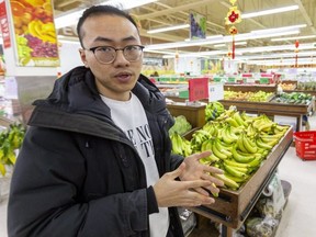 Fa Zhang, the manager of United Supermarket on Adelaide Street North shows the receipts with donations hi-lited. The store was hurt by the corona virus scare but now they are raising funds to help a national virus research charity. (Mike Hensen/The London Free Press)