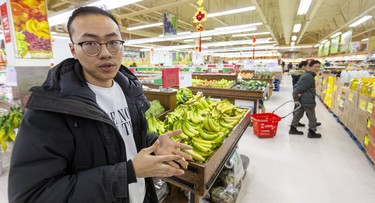 Fa Zhang, the manager of United Supermarket on Adelaide Street North shows the receipts with donations hi-lited. The store was hurt by the corona virus scare but now they are raising funds to help a national virus research charity. (Mike Hensen/The London Free Press)