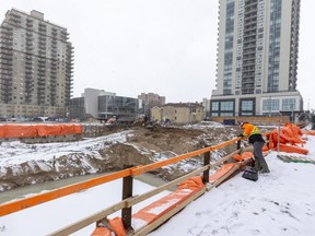 Braden Dufault of RTWH engineering monitors the shorings at Old Oak properties Centro project on Talbot Street between Fullarton street and Dufferin Avenue in London, Ont.  The shorings are installed to hold the soil back to protect the workers as excavation continues for the basement and foundations of the tower, which is planned for 40 floors. (Mike Hensen/The London Free Press)