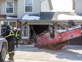 A tow truck prepares to remove a pickup truck that flipped upside down and crashed into a Jalna Boulevard in London early Friday morning. Photo taken on Feb. 21, 2020. (Mike Hensen/The London Free Press)