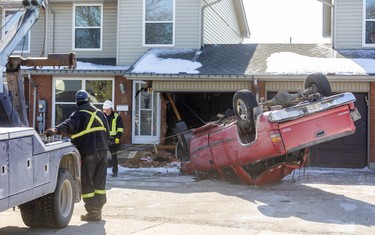 A tow truck prepares to remove a pickup truck that flipped upside down and crashed into a Jalna Boulevard in London early Friday morning. Photo taken on Feb. 21, 2020. (Mike Hensen/The London Free Press)