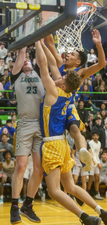 Laurier's Spencer Kanters gets fouled as the tenacious defence of Beal's Allen Roeun and Oscar Pensa pin him up against the backboard during their WOSSAA AAA senior boys semi-final played at home on Wednesday February 26, 2020. Last week in the city final, Beal won 79-59, but Beal coach Brian Harvey said, "it's tough to beat a team twice in a row, and their home gym is worth 10pts."
And it was, after trailing throughout the first half, a rousing third quarter had the teams tied at 33 heading into the fourth.
The fourth didn't disappoint with Laurier's raucous home gym keeping the team fired up, with Beal leading 47-46 with 4.4 seconds to play, a basket made it 49-46 with 3 seconds and then a technical foul made it 50-46 for the final.
Beal will face CCH in the WOSSAA AAA final.
Mike Hensen/The London Free Press/Postmedia Network