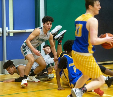 Four guys on the floor fighting over the ball was not uncommon during the WOSSAA semi-final between Laurier and Beal on Wednesday February 26, 2020. Last week in the city final, Beal won 79-59, but Beal coach Brian Harvey said, "it's tough to beat a team twice in a row, and their home gym is worth 10pts."
And it was, after trailing throughout the first half, a rousing third quarter had the teams tied at 33 heading into the fourth.
The fourth didn't disappoint with Laurier's raucous home gym keeping the team fired up, with Beal leading 47-46 with 4.4 seconds to play, a basket made it 49-46 with 3 seconds and then a technical foul made it 50-46 for the final.
Beal will face CCH in the WOSSAA AAA final.
Mike Hensen/The London Free Press/Postmedia Networkin London, Ont. 
Photograph taken on Wednesday February 26, 2020. 
Mike Hensen/The London Free Press/Postmedia Network