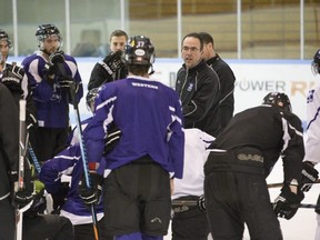 Head coach Clarke Singer speaks to his team during Western Mustangs hockey practice. (File photo)