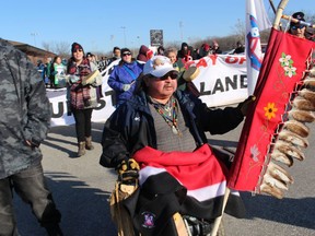 Mike Plain, an elder at Aamjiwnaang First Nation, leads Friday's march through Sarnia's Chemical Valley held to support those opposing a nature gas pipeline being built on the Wet'suwet'en territory in British Columbia.