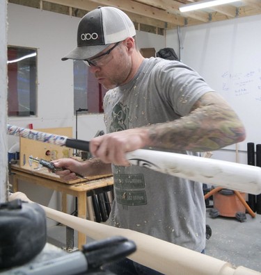 Trevor Oakes uses an old bat to check the measurements on a new bat, Saturday at ABO Baseball. (Chris Abbott/Tillsonburg News) ORG XMIT: POS2002032141011850