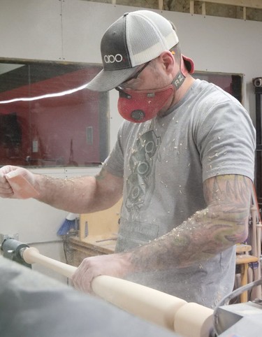 Trevor Oakes sands a bat on the lathe Saturday at ABO Baseball. (Chris Abbott/Tillsonburg News) ORG XMIT: POS2002032139501843