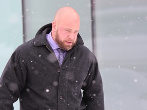 London police Const. Wesley Reeves, shown leaving London police headquarters in this file photo, must resign Wednesday or he will be fired. The Ontario Civilian Police Commission has upheld a tribunal ruling giving Reeves seven days to submit his resignation or face termination after he pleaded guilty to five counts of professional misconduct.  (Free Press file photo)