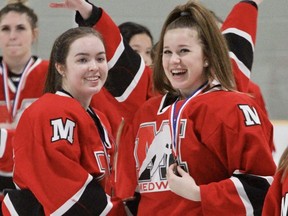 Medway's Ava Lewis, left, and Sarah Kennedy share a laugh after winning gold over Stratford secondary at the WOSSAA AAA girls' hockey championships Tuesday in Stratford. Medway will compete at OFSAA March 25-27 in Windsor. (Cory Smith/Postmedia Network)