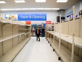 The toilet paper aisle is seen empty as people shop at a Walmart Supercentre in Toronto, Ontario, Canada March 13, 2020. (REUTERS/Carlos Osorio)