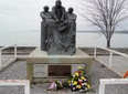 Fresh flowers were placed at the foot of the Fishermen’s Memorial in Port Dover this week. Norfolk OPP have confirmed that a commercial fisherman fell overboard Monday morning in Lake Erie and was still unaccounted for Tuesday. – Monte Sonnenberg photo