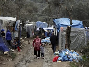 Mother with her daughter at a makeshift camp for refugees and migrants next to the Moria camp, on the island of Lesvos, on March 5, 2020 in Mitilini, Greece. Thousands of refugees and migrants have flocked to the Greece, Turkey border after Turkey announced that it would open border gates for a period of 72hrs to allow refugees to cross into European countries after thirty three Turkish soldiers were killed in a Syrian air raid in Idlib. (Photo by Milos Bicanski/Getty Images)