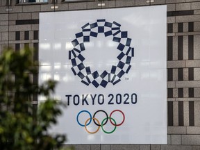 A Tokyo 2020 Olympics banner is displayed on a building, on March 19, 2020 in Tokyo, Japan. (Photo by Carl Court/Getty Images)