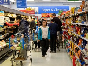 People gather supplies at a grocery store amid coronavirus fears spreading in Toronto.
(Reuters/CARLOS OSORIO)