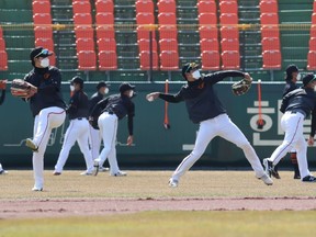 Players of Hanwha Eagles, a South Korean professional baseball club, wearing face masks amid concerns of the COVID-19 coronavirus, participate in a training session at Hanbat baseball stadium in Daejeon on March 12, 2020. - South Korea reported fewer than 120 new coronavirus cases on March 12, but authorities warned that a new cluster in Seoul could see the infection spread in the capital. (Photo by - / YONHAP / AFP) / - South Korea OUT / REPUBLIC OF KOREA OUT  NO ARCHIVES  RESTRICTED TO SUBSCRIPTION USE (Photo by -/YONHAP/AFP via Getty Images)