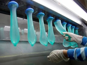 A worker performs a test on condoms at Malaysia's Karex condom factory in Pontian, 320 km (200 miles) southeast of Kuala Lumpur November 7, 2012.