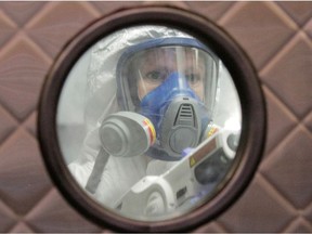 Jaime Casady uses an electrostatic sprayer to disinfect the Uncle Ike's pot shop, during the coronavirus disease (COVID-19) outbreak, in Seattle, Washington, U.S. March 26, 2020.