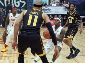 Sudbury Five guard Braylon Rayson (2) pulls up for a shot while Cameron Forte (11) and Marcus Capers (60) of the London Lightning defend and Jaylen Bland (1) of the Five watches the play during NBLC action at Sudbury Community Arena in Sudbury on Saturday, March 7, 2020. (Ben Leeson/Postmedia Network)
